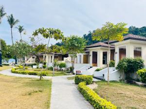 a house with a walkway in front of a yard at Koh Hai Fantasy Resort & Spa in Ko Ngai