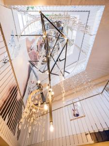 a chandelier hanging from a ceiling in a room at Art Hotel Tartini in Piran