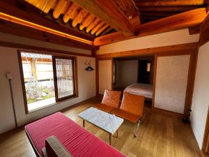 a room with a bedroom with a bed and a table at soyeonjae 소연재 in Gyeongju