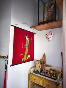a room with a red flag and a table with a teddy bear at Kyoto151 in Kyoto