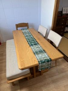 a wooden table with two chairs and a blanket on it at Kyoto151 in Kyoto