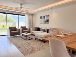 a living room with a couch and a table at North Island View Family Duplex with private pool by LOV Mauritius in Grande Gaube