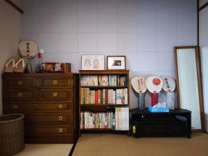 a room with a dresser and a book shelf with trophies at Kyoto151 in Kyoto +21 photos