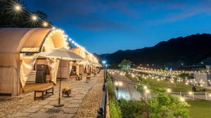 a row of tents with lights at night at Mungyeong The Most Glamping in Mungyeong