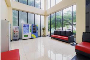 a waiting room with two couches and windows at SANS Vibes Hotel Igloo Cikarang in Cibitung