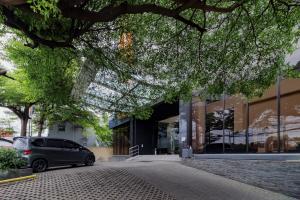 a car parked in front of a building at SANS Vibes Hotel Igloo Cikarang in Cibitung