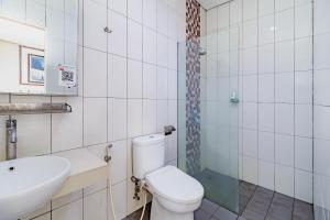 a bathroom with a toilet and a sink at SANS Vibes Hotel Igloo Cikarang in Cibitung +31 photos