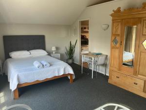 a bedroom with a bed with two towels on it at Fremantle Local Beach Studio in Fremantle