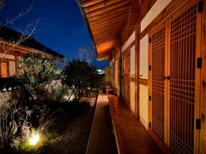 an empty hallway of a building at night at soyeonjae 소연재 in Gyeongju