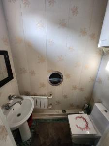 a small bathroom with a toilet and a sink at Апартаменты in Tashkent +6 photos