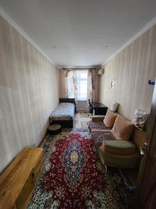 a living room with a couch and a rug at Апартаменты in Tashkent