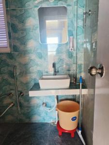 a bathroom with a sink and a mirror at Pinaceae Resort in Chakrāta +32 photos