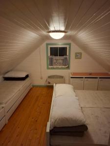 a room with two beds and a ceiling at Brunarica Beti in Brežice