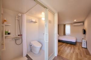 a bathroom with a shower and a toilet in it at HOTEL R9 The Yard Tamba in Isō +20 photos
