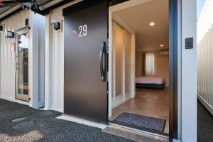 a door with the number twenty on it in a hallway at HOTEL R9 The Yard Tamba in Isō