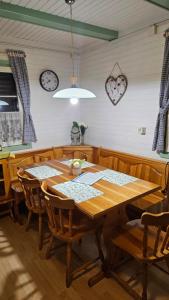 a dining room with a wooden table and chairs at Brunarica Beti in Brežice