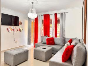 a living room with a couch and red curtains at 1Dom Rep - Huge cozy 3 bedrooms - close to all transportation Jacobo Majluta - Residencial Paradise V Colina Arroyo 1 in Santo Domingo