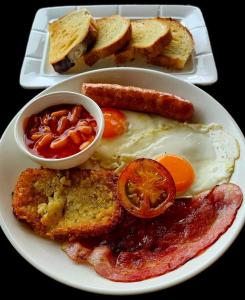 a plate of breakfast food with eggs bacon and toast at The Bay Lookout in Kaôh Rŭng (3) +3 photos