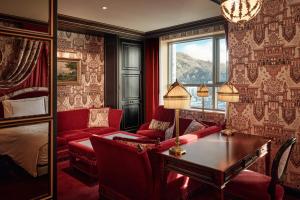 a bedroom with red furniture and a bed and a table at L'Escape, a Luxury Collection Hotel, Seoul Myeongdong in Seoul