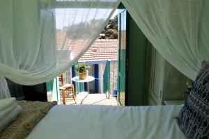 a bedroom with a bed and a view of a patio at To Konatzi tis Marikas tzai tou Yianni in Kato Drys