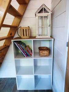 a book shelf in a attic with a window at Climatisation avec La Rouyonnaise in Tinténiac