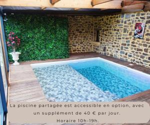 a swimming pool in the middle of a patio at Climatisation avec La Rouyonnaise in Tinténiac