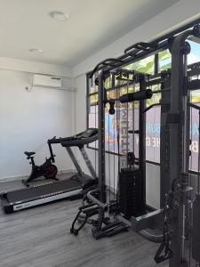 a room with a gym with two tread machines at Ranbin Retreat in Manadhoo