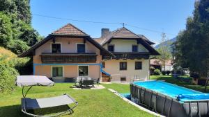a house with a swimming pool in front of it at Urlaub am Bauernhof Gänser in Sankt Peter am Kammersberg