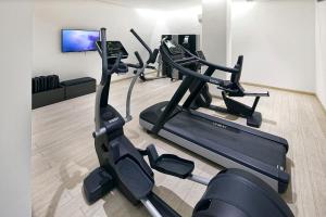 a gym with two tread machines in a room at Parco Smeraldo Appartamenti in Ischia