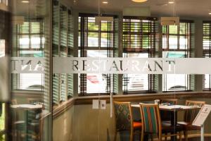 a restaurant with a sign that reads restaurant at Leonardo Inn Aberdeen Airport in Dyce