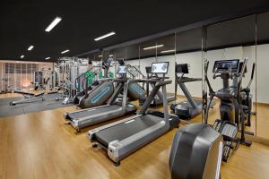 a gym with several treadmills and cardio machines at La Siesta Premium Lakeside in Hanoi