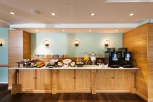 a kitchen with a counter with food on it at Leonardo Inn Aberdeen Airport in Dyce