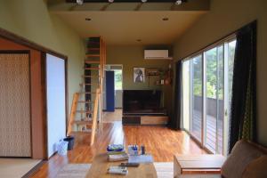 a living room with a couch and a table at スローライフ喜界 in Onozu