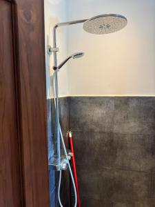 a shower in a bathroom with a shower head at The Ellen Horizon in Ganegama South