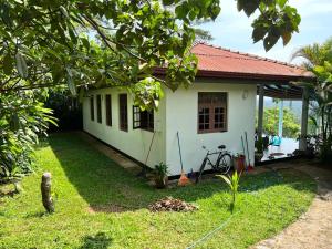 a small white house with a bicycle in front of it at The Ellen Horizon in Ganegama South