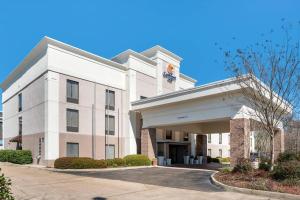 a large white building with a sign on it at Comfort Inn Pearl-Jackson in Pearl