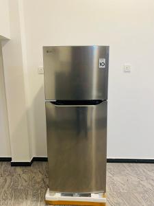 a stainless steel refrigerator sitting in a kitchen at Wishwa Villa in Weligama