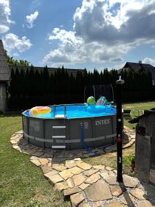 a swimming pool with a ladder in a yard at Drevenica MATAJKA in Kvačany