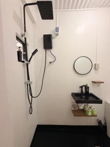 a bathroom with a sink and a mirror at New Studio with Balcony , General Luna in General Luna