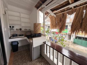 a kitchen with a counter and a large window at New Studio with Balcony , General Luna in General Luna