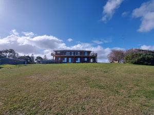 a large house on top of a grass field at Magic at the Mouth in Nelson