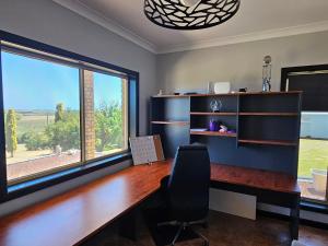 an office with a desk and a large window at Magic at the Mouth in Nelson