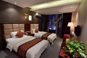 a hotel room with two beds and a tv at Wo Er Si Hotel in Fusong +38 photos