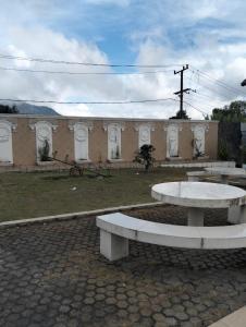 a group of benches in front of a building at Villa Bukit Asri Berastagi in Berastagi