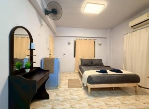 a bedroom with a bed and a piano at Saan Stay in Ban Krabi Yai