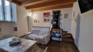 a living room with a couch and a table at Casetta gialla in Brianza - Monticello Brianza - NON E' CASATENOVO in Casatenovo +9 photos