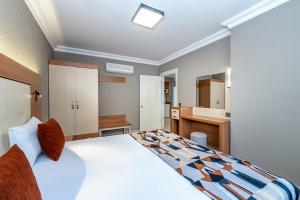 a bedroom with a large bed and a bathroom at Villa Sunflower Hotel - All Inclusive in Alanya