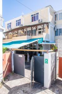 a building with a gate in front of a building at Chez Jenny port Mathurin in Rodrigues Island