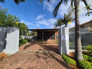 a house with a gate and a brick driveway at The Marley in Polokwane