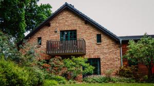 a brick house with a balcony on it at KASTANIENHOF in Burg